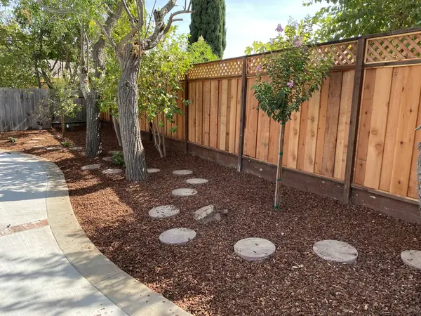 Cedar fence with a lattice top along a curved path