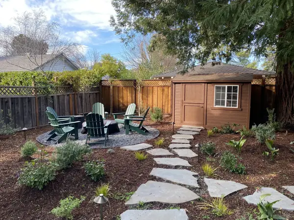 Gravel fire pit area with chairs, flagstone steppers and new planting