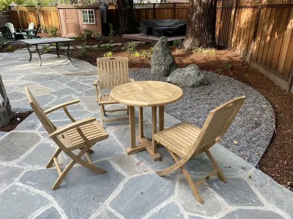 Flagstone patio with a bistro table and boulders