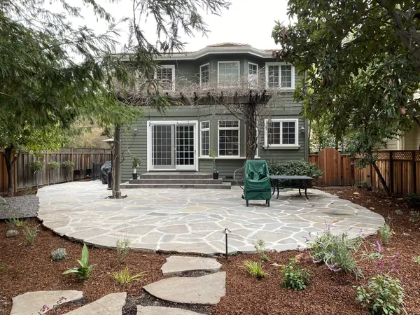 Round flagstone patio with stepping stones, new planting and path lights