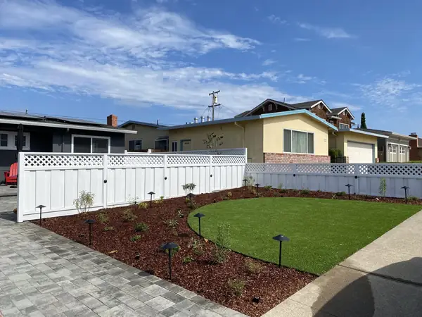 Curved lawn with planting beds and path lights