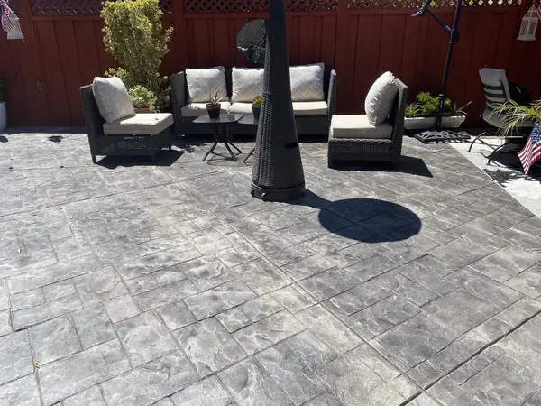 Stamped concrete patio with outdoor sofa and chairs
